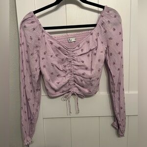 Lavender cropped style blouse with violet floral design pattern throughout